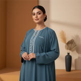 Portrait of Zahra Al-Husseini, a young woman with a confident expression, wearing a modern modestwear garment.