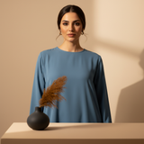 Portrait of Layla Mansour, an elegant woman with a confident expression, wearing a modern modestwear garment. Her head and sh