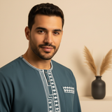 Portrait of Karim Said, a man with a modern modestwear and luxury streetwear aesthetic, against a warm cream background.